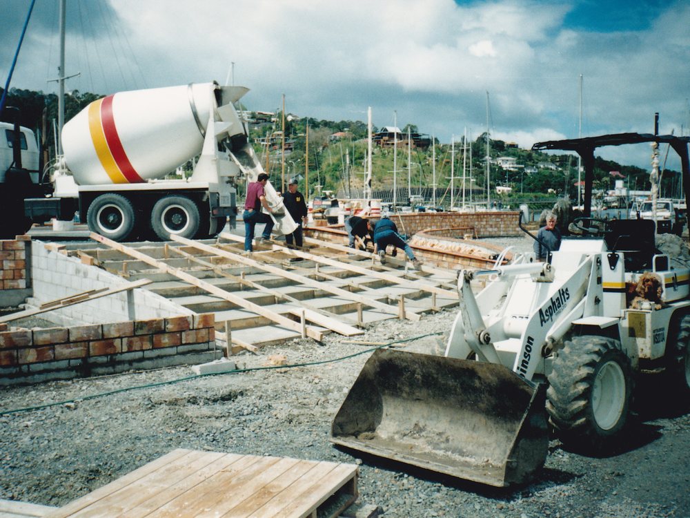 Concrete being poured for the Town Basin steps with a Robinson Asphalts loader in front