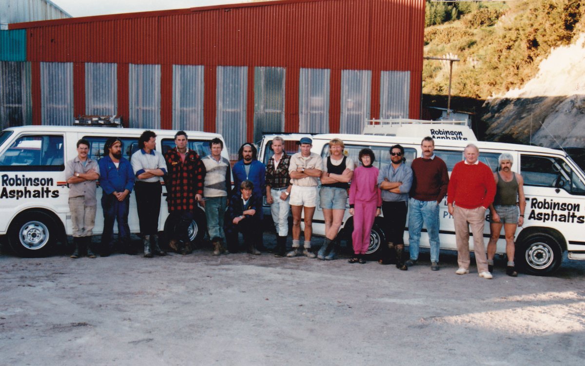 The early Robinsons crew lined up in front of the company vans