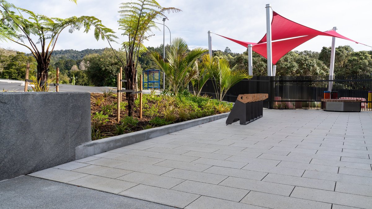 Large-format paving, tree ferns and red shade sails at Tira Ora, Whangārei Hospital