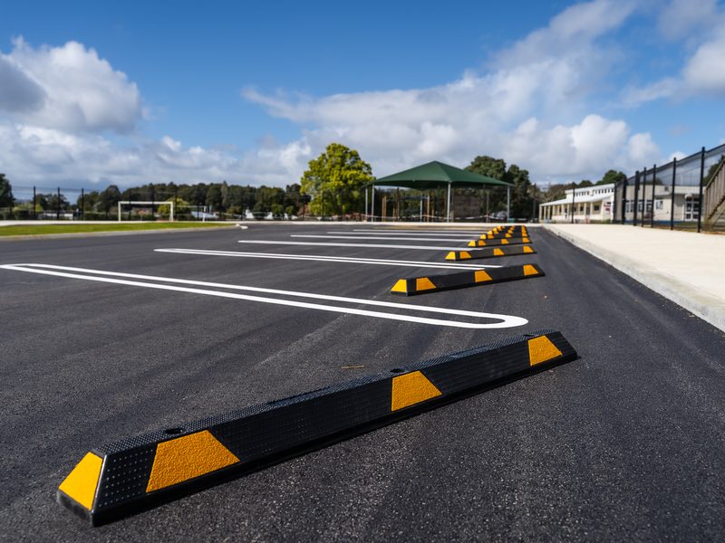 Wheel stops and fresh line marking in a new school carpark
