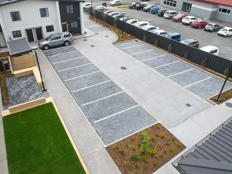 Paver parking bays, concrete accessway and planting at a residential development