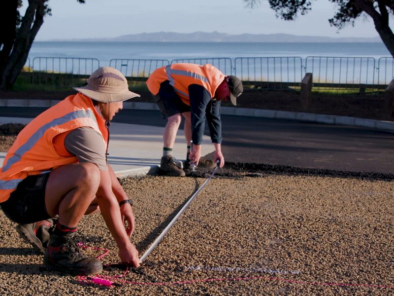 Robinsons crew setting out a new carpark by the coast
