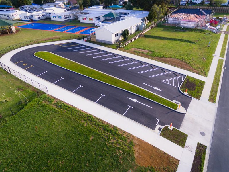 Aerial view of a new school carpark with a planted median