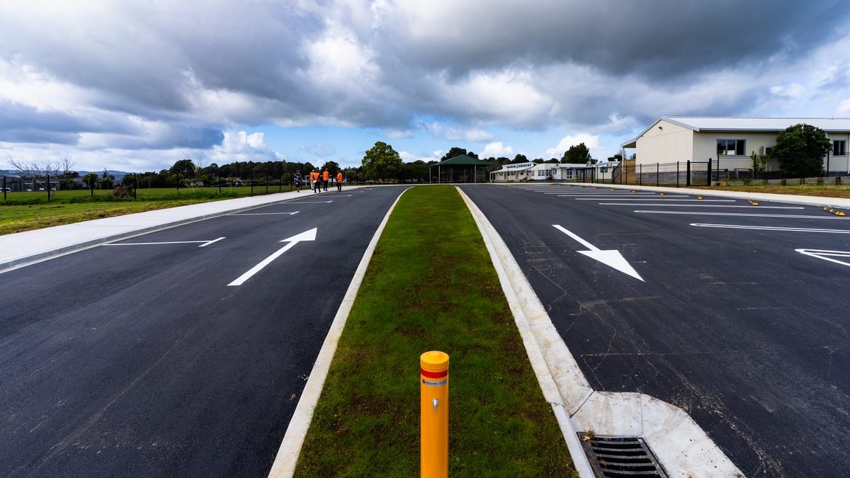 Carpark median with kerbs, grass island, bollard, drainage sump and line marking