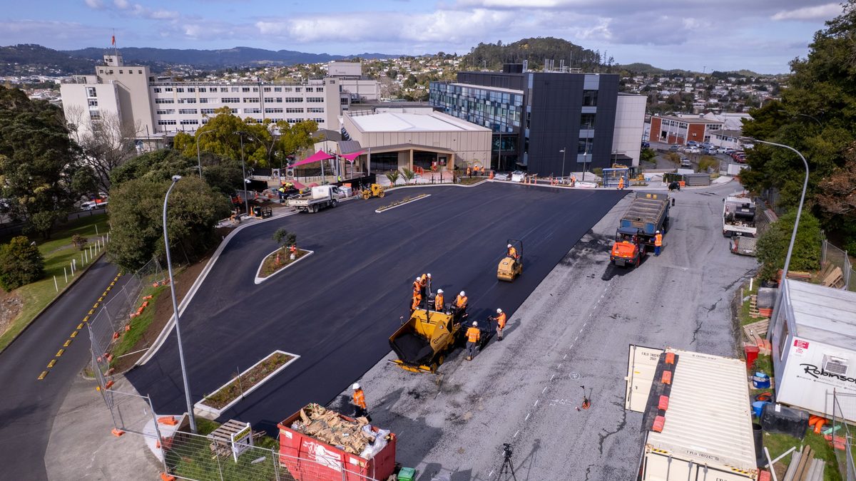 Robinsons crew laying a hotmix overlay with a paver and roller