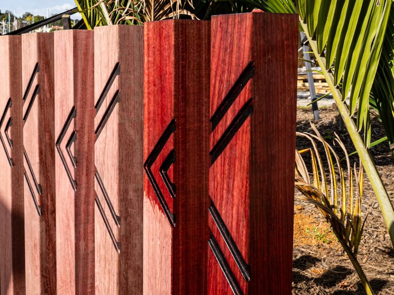 Carved purpleheart fence posts at Pūtahi Park, Whangārei
