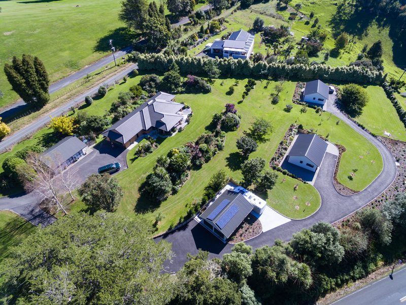 Hotmix road with kerbs and planting serving rural-residential lots