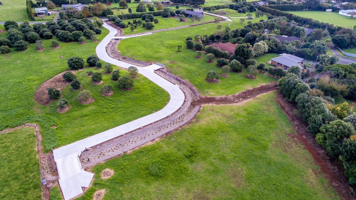 Aerial view of the Te Mara Estate subdivision road, bridges and raingardens, Maungatapere