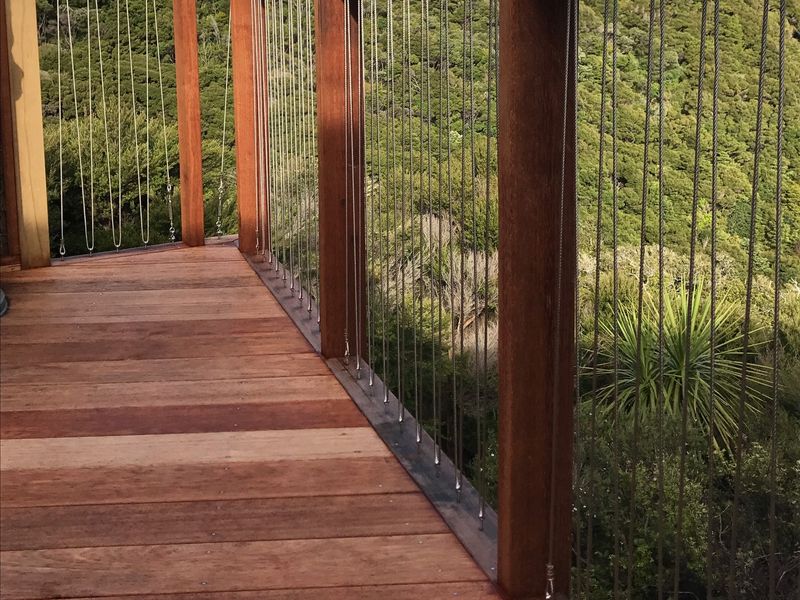 Hardwood deck with timber posts and cable balustrade overlooking native bush