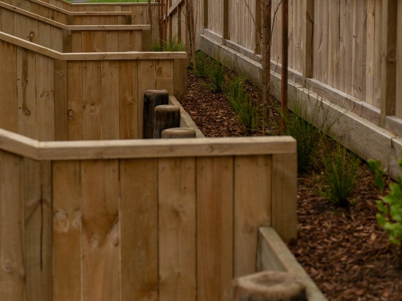 Timber fence and stepped timber retaining walls with new planting