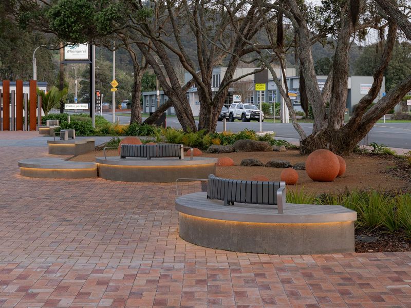 Concrete play spheres, lit seating and planting at a civic centre forecourt
