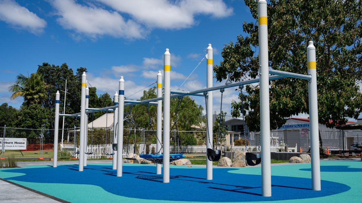 Swing set on blue and teal safety surfacing