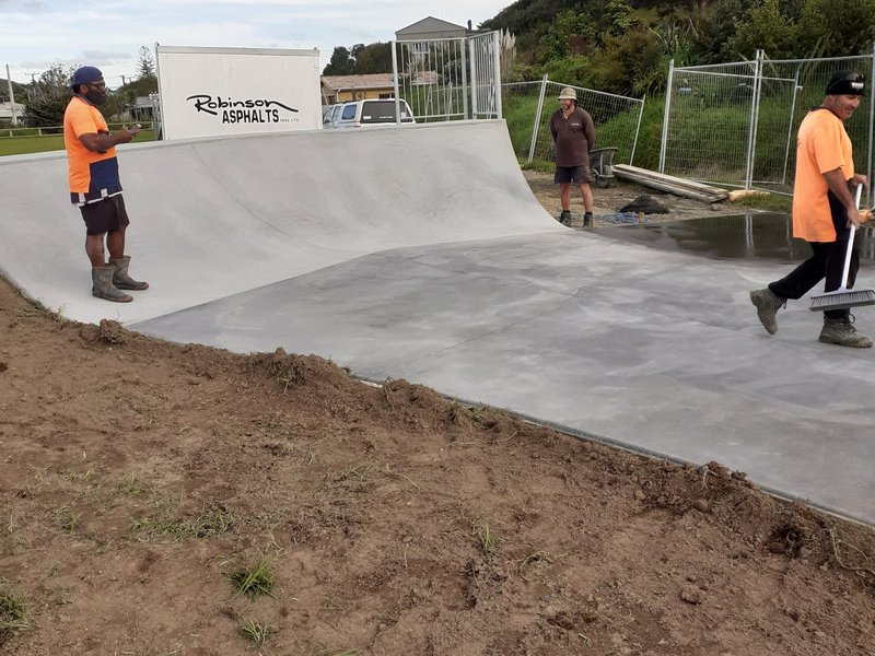 Newly finished concrete skatepark ramp with the Robinsons crew