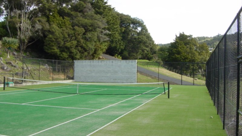 New home tennis court with fencing on a lifestyle property