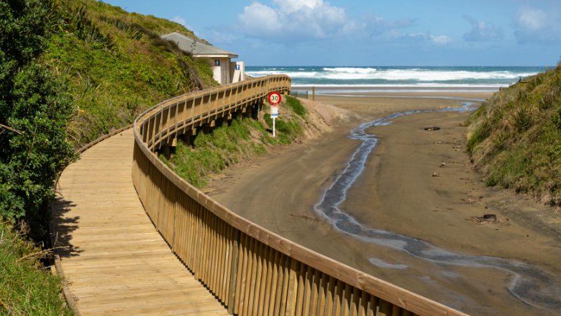 Timber boardwalk curving down to Baylys Beach