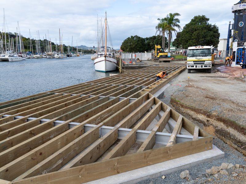 Timber boardwalk framing being built beside the Hātea River at Pūtahi Park, Whangārei