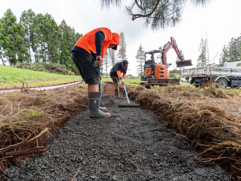 Crew spreading basecourse for a new walking path